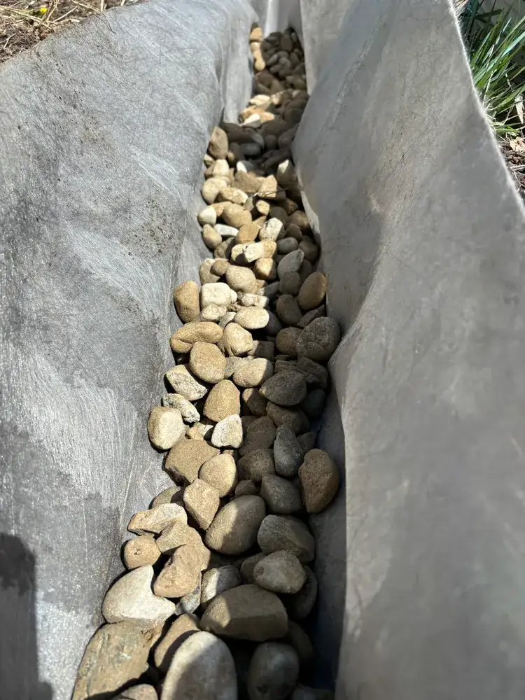 Fabric-lined trench filled with river rock