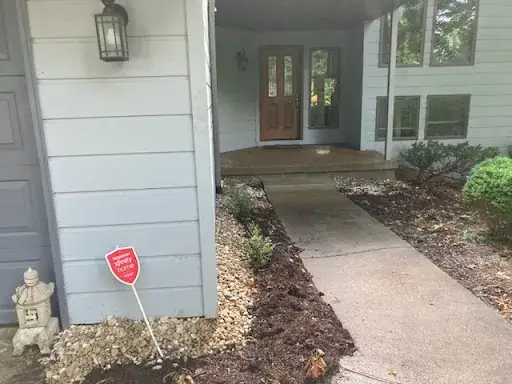 River rock foundation swale along the front of a house beside the front walk